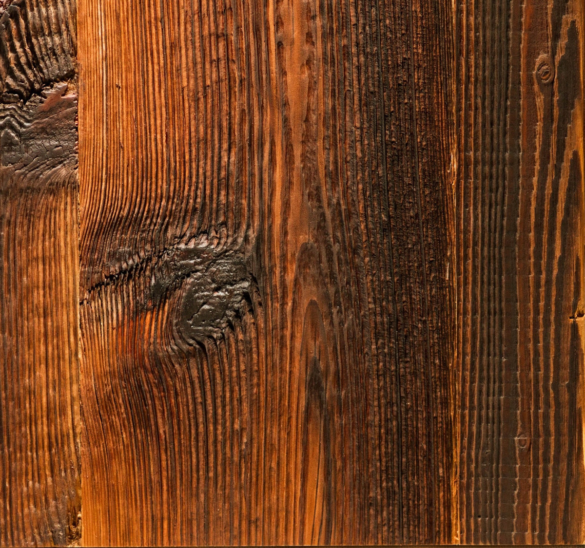 A sample of reclaimed wood for shelves and worktops with a rich brown and amber finish, showcasing detailed grain and knots,