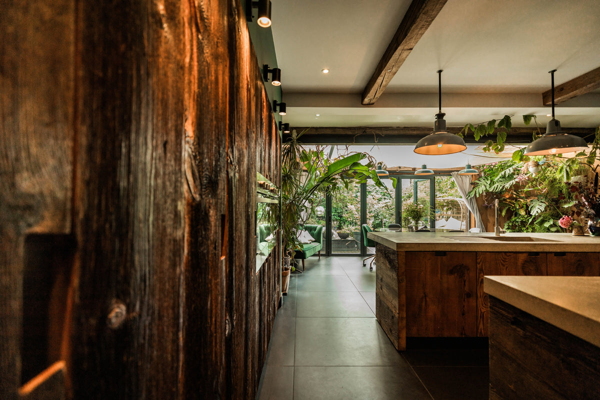 reclaimed barn wood tall kitchen door handcrafted in the uk with plants and a garden view